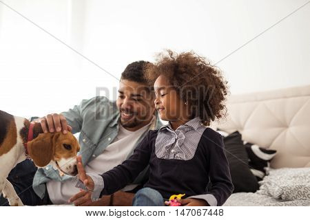 African american family playing with a dog.