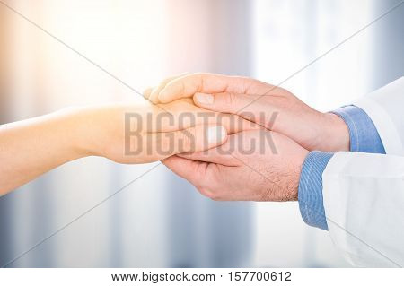 doctor patient care holding human hand trust touch medical thanks help clinic health concept - stock image