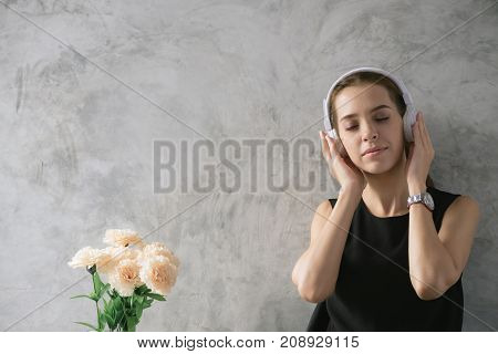 Woman love music. Young woman listening music while thinking woman doing homework in modern place woman working with happy emotion concept. Portrait of happy woman listening musical. Pretty woman listening music with her headphones in the home.