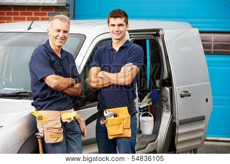 Workers In Family Business Standing Next To Van