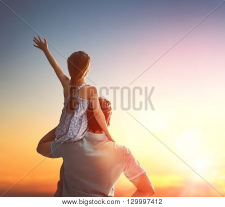 Happy loving family. Father and his daughter child girl playing and hugging outdoors. Cute little girl and daddy. Concept of Father's day.