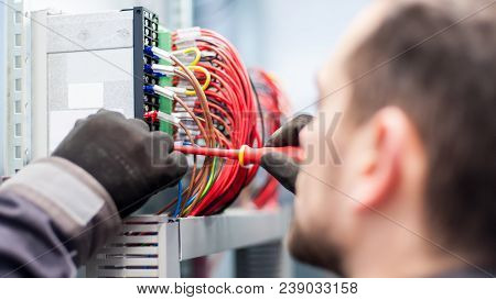 Closeup Of Electrician Engineer Works With Electric Cable Wires