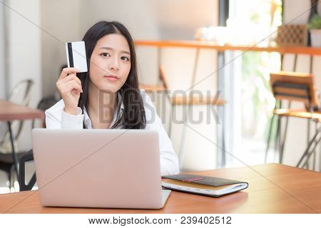 Beautiful Young Asian Woman Holding A Credit Card And Shopping Online With Using Laptop Computer At 