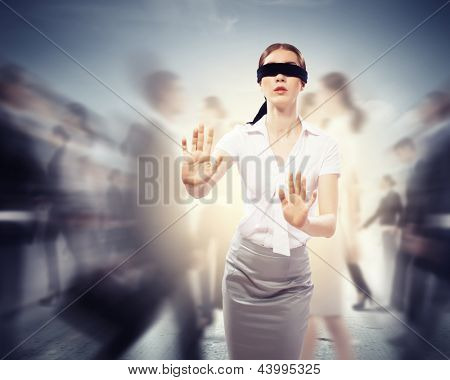 Image of businesswoman in blindfold walking among group of people