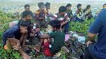 Dozens of people, believed to be Rohingya Muslims from Myanmar who were dropped off from a boat are pictured on a beach near Sungai Belati, Perlis, Malaysia in this undated handout photo released April 8, 2019. Malaysian authorities on Monday were on the lookout for boats believed to be carrying up to 200 Rohingya after dozens of migrants were found near a beach in the country's north. Royal Malaysian Police/Handout via REUTERS