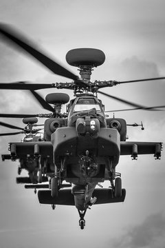 A stack of three Apache attack helicopters head-on