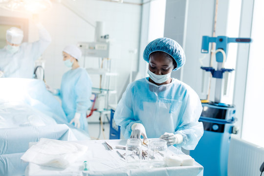 afro beautiful female doctor holding tray with medical tools for surgery,close up photo. lifestyle