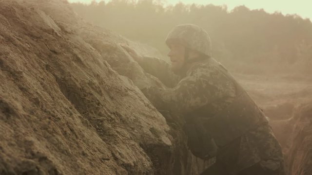 Hostilities. Hands Of Soldier Holding Grenade. He Throws It Away.