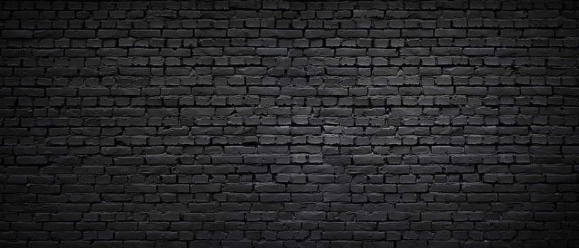 Texture of a black painted brick wall as a background or wallpaper