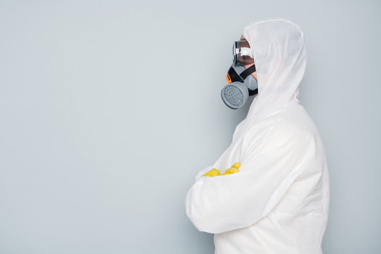 Profile photo of epidemic specialist guy disinfectant watch public places disinfecting cleaning arms crossed wear white hazmat protective suit goggles mask isolated grey color background