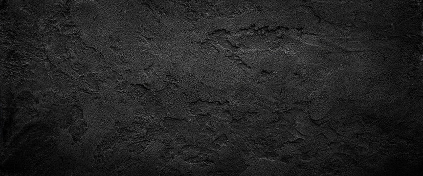 Black or dark gray rough grainy stone texture background