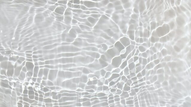 Pure water with reflections sunlight in slow motion. Water surface texture top view. Sun and shadows. Motion clean swimming pool ripples and wave. High quality 4k footage