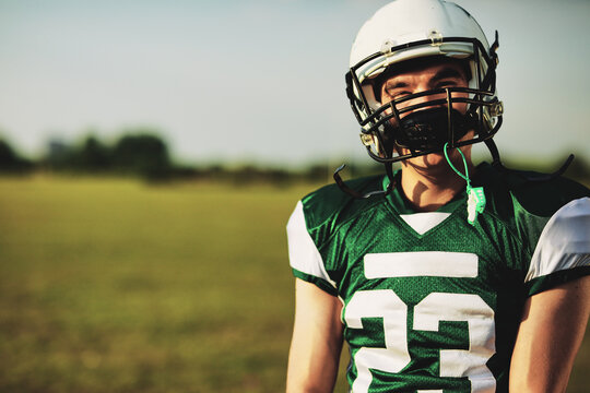 Smiling football player standing on a field