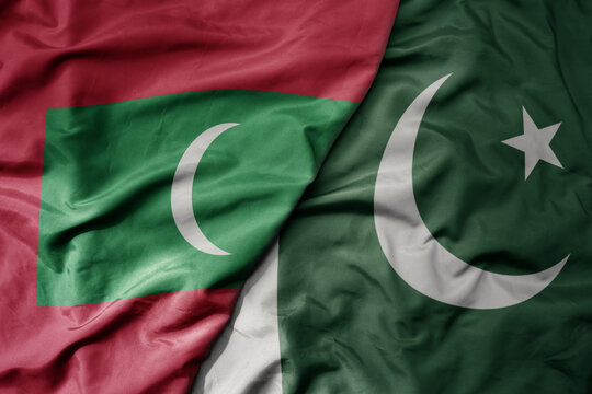 big waving realistic national colorful flag of maldives and national flag of pakistan .