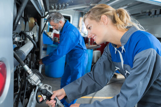 beautiful woman auto mechanic in blue overalls