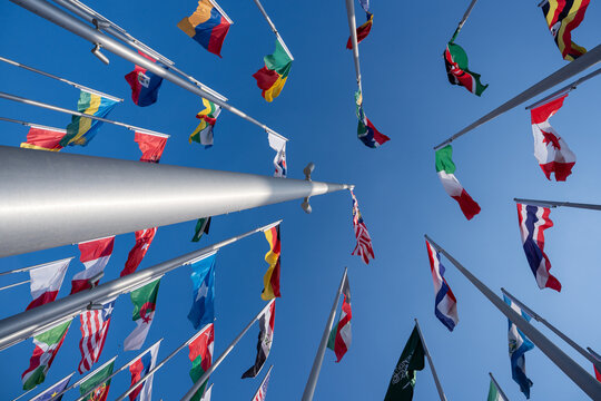 Various flags of the world against the blue sky.