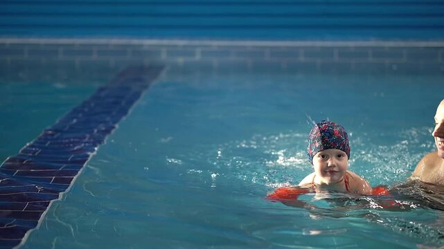 baby in water.family in pool.slow motion video.high quality footage 4k