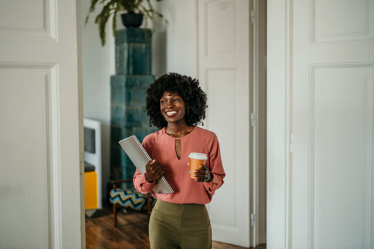 Portrait of a confident young businesswoman showing positivity while walking for a meeting in a modern office