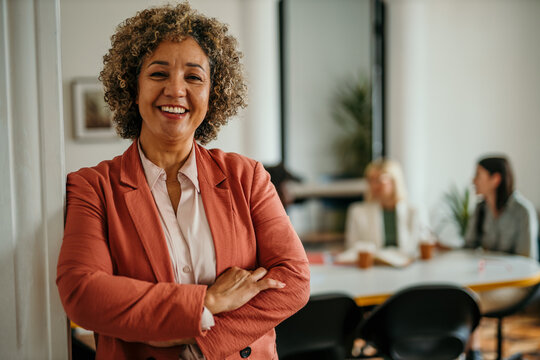 Portrait of an confident senior diverse businesswoman, with arms crossed at the modern office