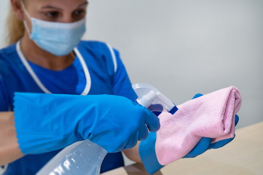 A cleaning lady prepares a cloth and agents for cleaning