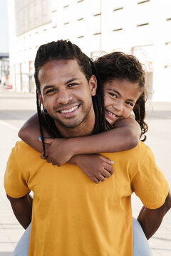 A beautiful portrait of dominican father and daughter looking at camera