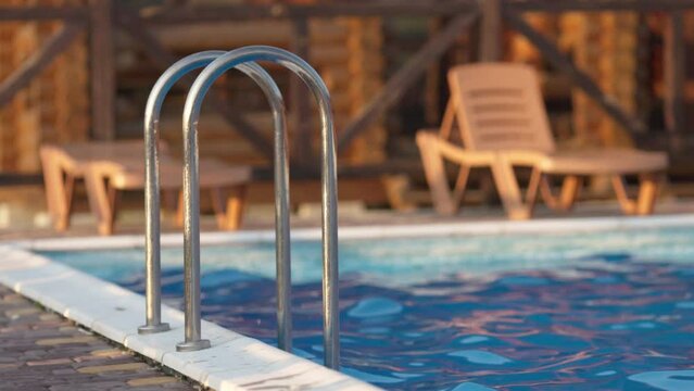 Top view of swimming pool with clear water on vacation on sunset background