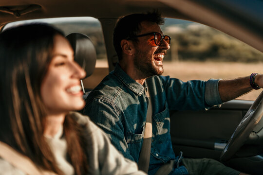 Young couple enjoying the freedom on a Car Trip over a country offroad