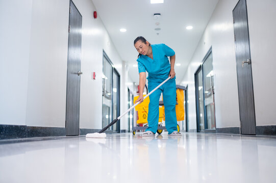 Asian female staff cleaning hospital floor