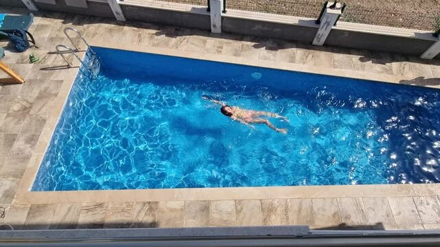 Woman swimming in the pool under water. 4k video footage UHD 3840x2160