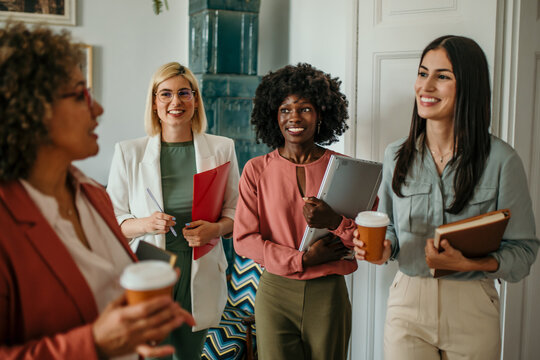 Shot of a group of confident business persons talking in the work place