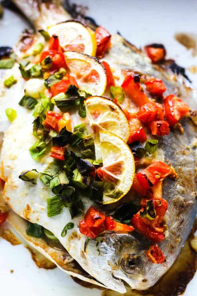 baked whole fish with tomatoes and lemons