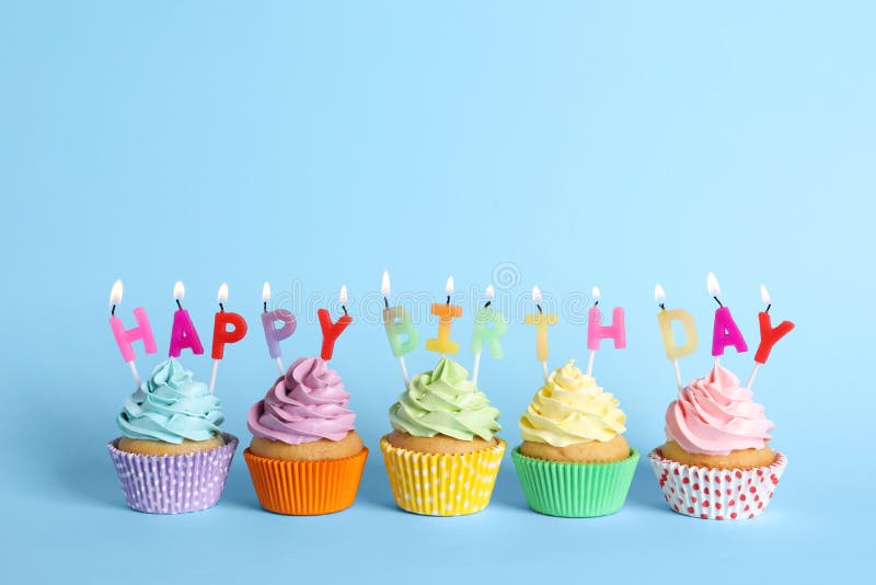 Birthday Cupcakes with Burning Candles on Light Blue Background Stock ...