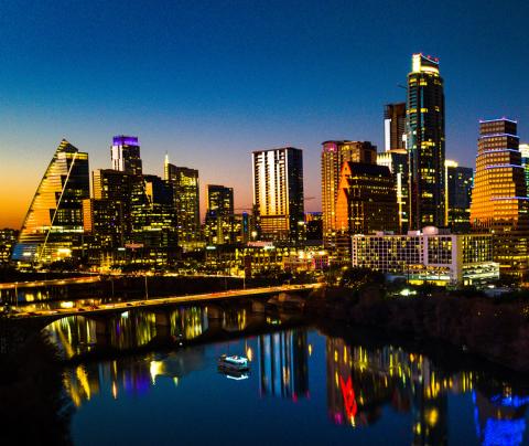 City of Austin downtown skyline at sunset reflecting in the lake