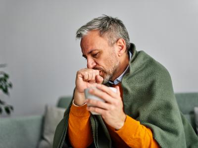 Ill middle-aged man on couch