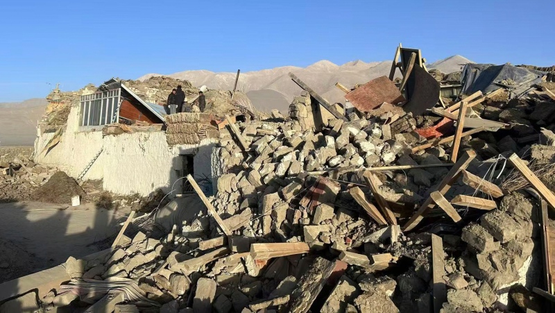 In this photo released by Xinhua News Agency, people stand amidst damaged houses in the aftermath of an earthquake in Tonglai Village, Changsuo Township of Dingri in Xigaze, southwestern China's Tibet Autonomous Region, Jan. 7, 2025. (Xinhua via AP)