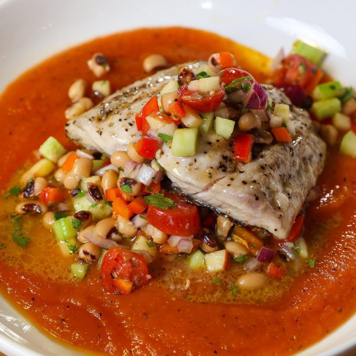 grilled mahi mahi on top of red papaya sauce and topped with blackeyed pea salad