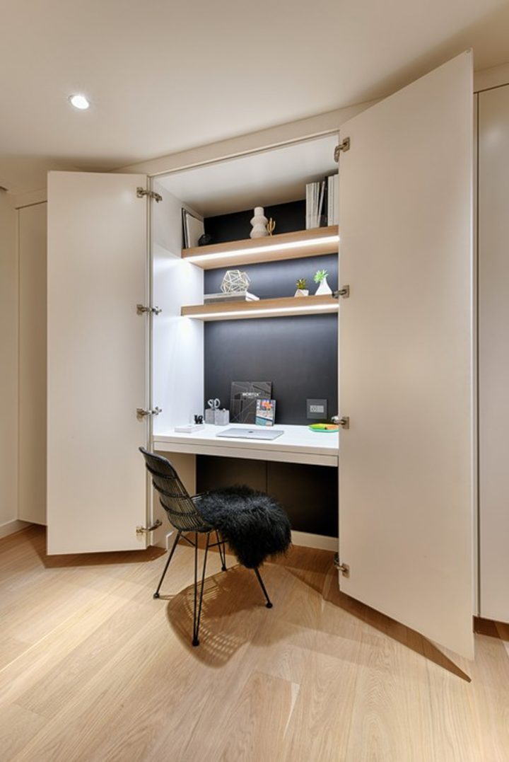 Closet home office with doors and lights under the shelves