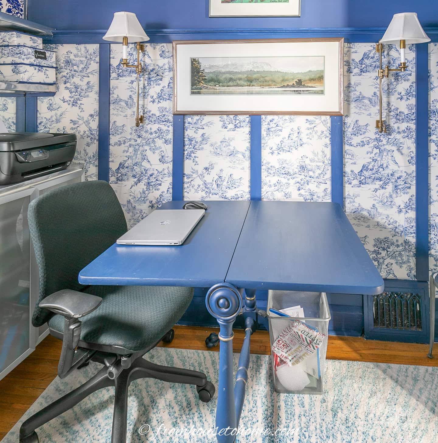 A blue drop leaf table used as a desk in a small home office