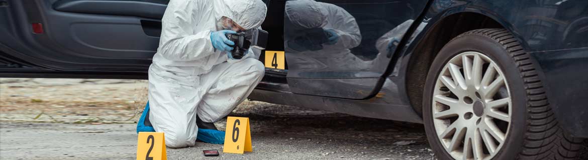 Forensic scientist examining the scene