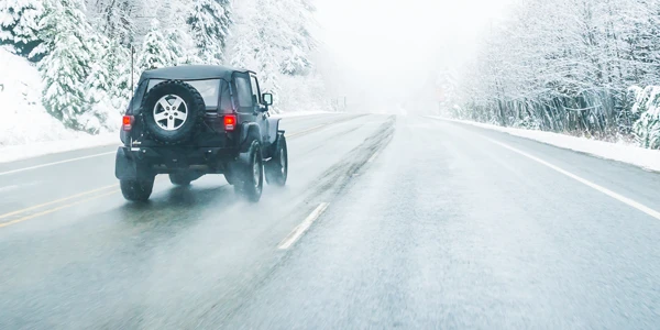 Jeep on snowy road.