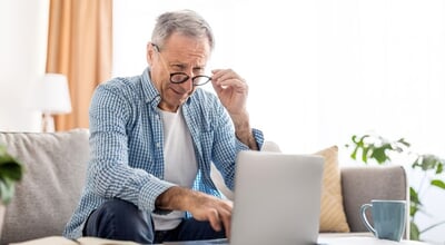 Eyesight,Problems.,Confused,Mature,Man,Wearing,Glasses,Working,On,Laptop