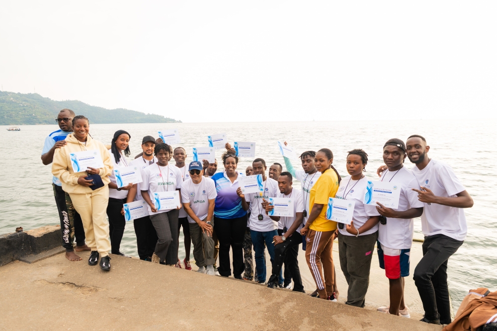 Swimming coaches pose for their certificates at the end of their coaching clinic at Lake Kivu beach in Rubavu District-courtesy