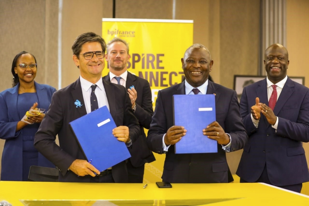 Equity Group Managing Director and CEO Dr. James Mwangi (R) and BPI France CEO Nicolas Dufourcq display the MoU between Equity and BPI France. Looking on in second row (L-R) is Managing Partner ALN Kenya, Rosa Nduati-Mutero, the French Ambassador to Kenya Arnaud Suquet and the Principal Secretary for Investment, Trade and Industry Alfred K’Ombudo.