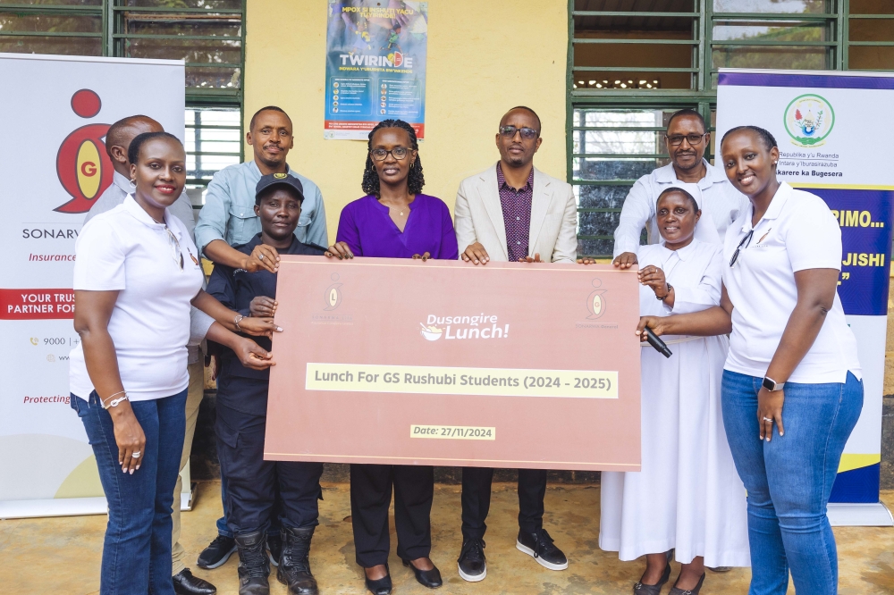 SONARWA Life Assurance Company Ltd and SONARWA General Insurance Company Ltd officials hand over a cheque to school officials at Groupe Scolaire Rushubi Catholique in Bugesera District. Courtesy