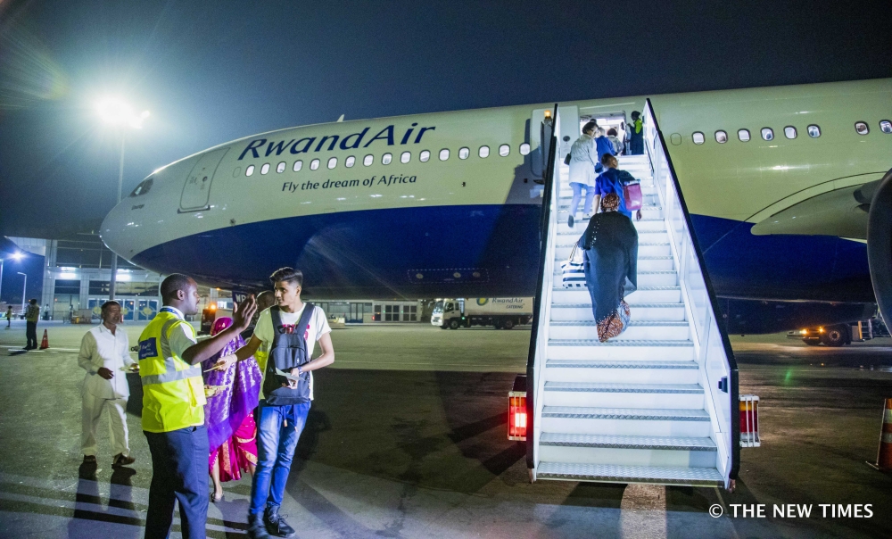 Passengers board a RwandAir plane at Kigali International Airport. Starting from Thursday, December 5, travelers from Rwanda will no longer be redirected to three designated U.S. airports.