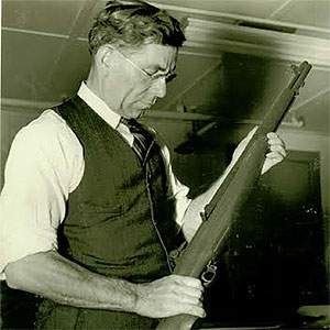 image of John Garand holding an M1 rifle stock