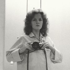 1/2 length self portrait in mirror, wearing pyjama shirt, camera at shoulder height, 1979 Carol Jerrems