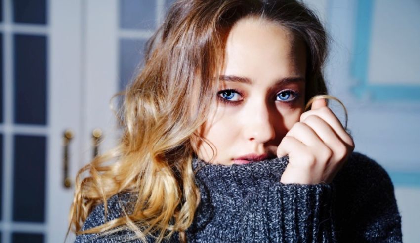 A woman with blue eyes is posing for a picture.