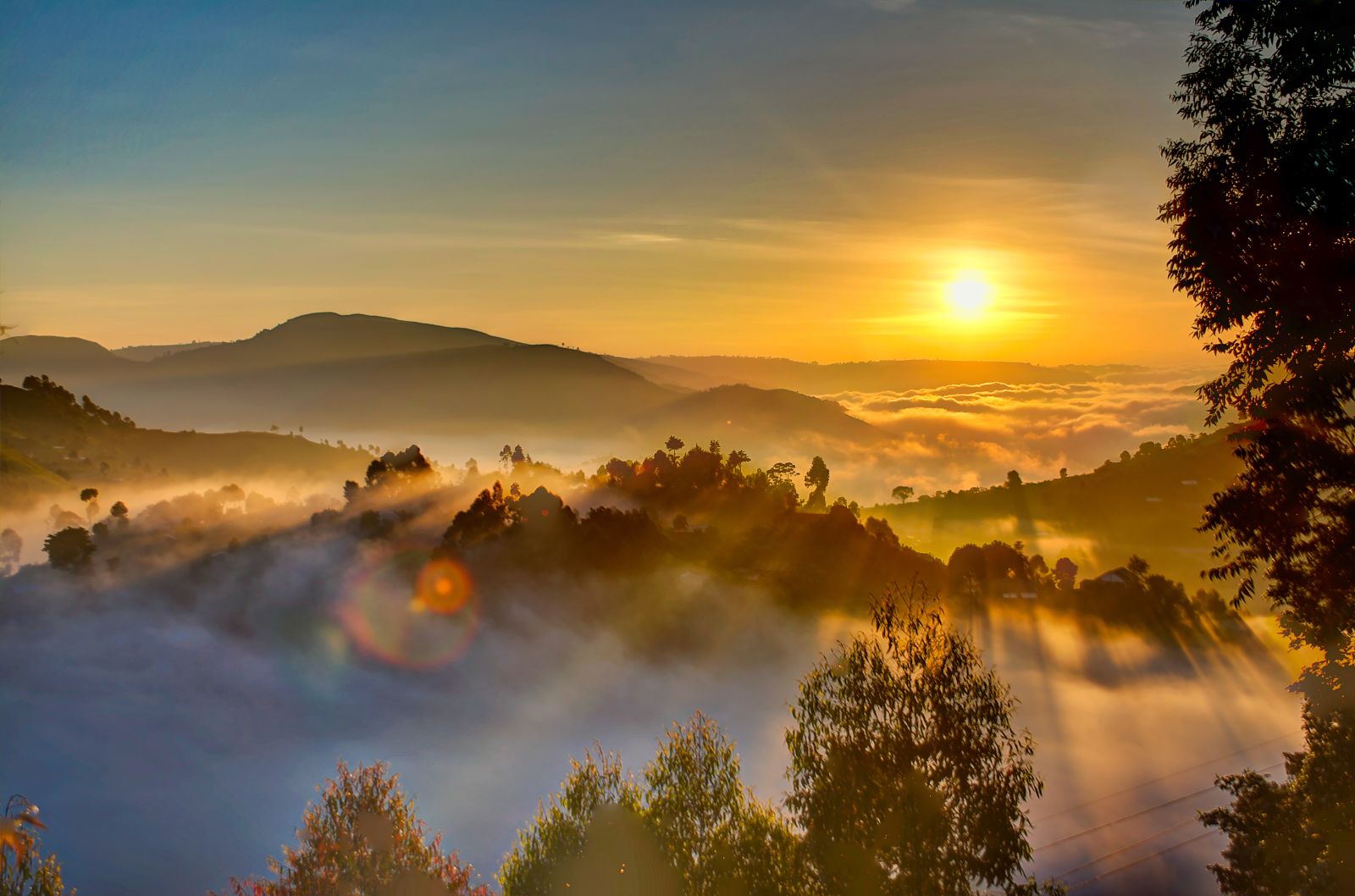 Sun rising over the misty hills of the highlands in Uganda