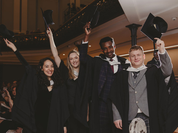 Graduates throwing their hats